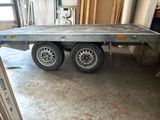 a flat bed trailer in the garage of a house