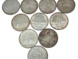 a lot of coins that are on a white surface