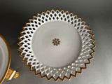 a white plate with a gold rim and a white plate with a gold rim