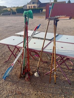 a lot of tools sitting on a table in the dirt