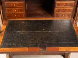 a desk with a black marble top and a wooden cabinet