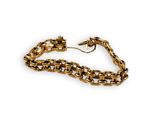 a close up of a gold chain bracelet on a white background