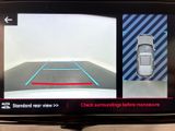 the rear view mirror of a car showing a car driving on the road