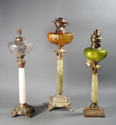 four different colored glass vases sitting next to each other on top of a table