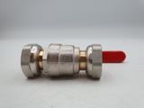 a close up of a metal ball valve with a red handle