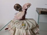 figurine of a ballerina in a pink dress on a glass table