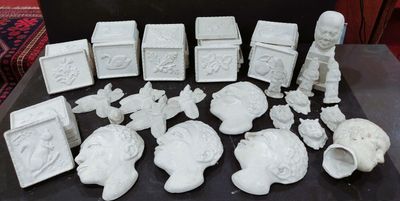 a lot of white figurines sitting on a table
