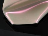 a pink and white object on a black surface