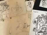 a lot of drawings on a table with a red chair in the background