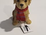 a brown dog wearing a red scarf and a red hat