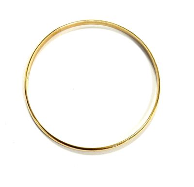 a close up of a gold ring on a white surface