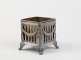 an image of a silver metal planter sitting on top of a white surface