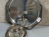 a silver plate with a silver lid on a table