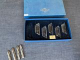 five pieces of silver in a blue box on a table