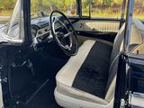 the interior of a black and white car with the door open