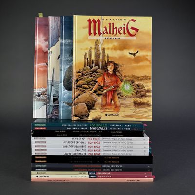 many books stacked on top of each other on a table