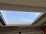 a skylight above a window in a small room