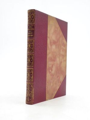 an old book sitting on top of a white table next to a white wall