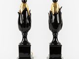 pair of black and gold vases with corn on the cob