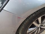 a close up of a car ' s tire on the side of the road
