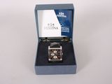 an image of a watch in a box on a white surface
