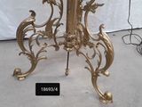 a gold table with a glass top and a clock on it