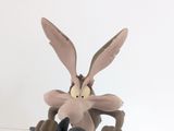 a figurine of a cartoon character riding a motorcycle