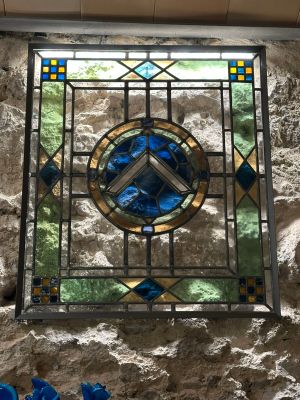 a stained glass window on the wall of a building