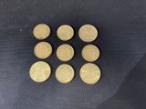 six british pound coins on a black background