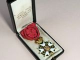 an image of a medal in a case with a red wax seal
