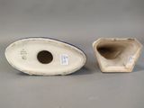 pair of porcelain vases with blue and white decoration on them