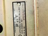 a close up of a metal plate with a label on it
