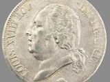 Gros plan sur une pièce de monnaie portant le visage d'un homme