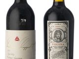 two bottles of red wine are sitting next to each other