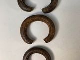 three pieces of wood are arranged on a white surface