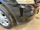 a close up of a car ' s front bumper with a hole in it