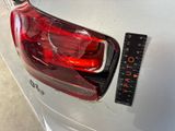 a close up of the tail light of a car with a ruler attached to it