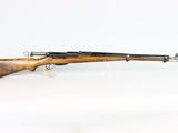 an old rifle with a wooden barrel on a white background