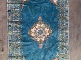 rug on the floor is blue and has a medallion design on it