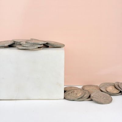 a white box filled with coins sitting on top of a table