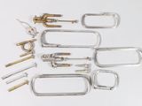 a lot of different types of metal tools on a white surface