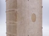 an old book that is sitting on a white surface