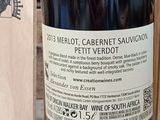 a bottle of wine sitting next to a box of wine