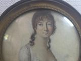 painting of a woman in a white dress is hanging on a wall