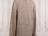 the back of a coat with a fur collar on a mannequin mannequin
