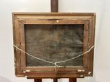 an old wooden easel with a painting on top of it