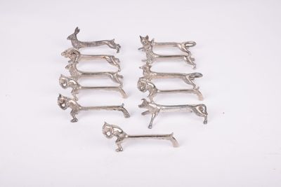 six antique silver plated dachshunds on a white background