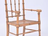 a wooden chair with a woven seat on a white background