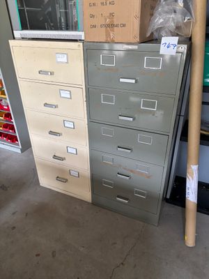 a stack of filing cabinets in a garage with boxes on top of them