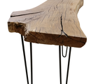 a wooden table with hairpin legs and a piece of wood on it